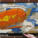 Zeppelin (medium) Recycled paper-tile mosaic. $361 Framed; 29.75×18” 232 tile pieces. tax-free. (the flag is the Independence flag from the show Firefly)